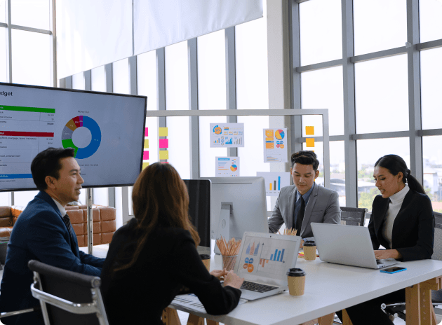 Vibrant Logics team analyzing a project dashboard together