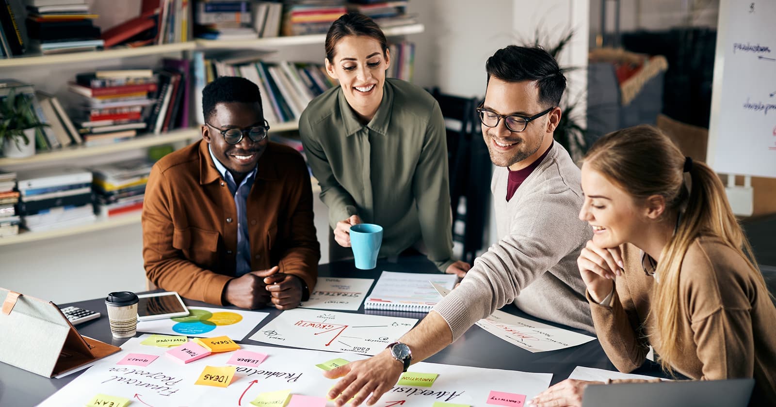 Vibrant Logics team collaborating around a table with sticky notes